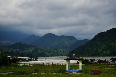 Built structure by mountains against sky