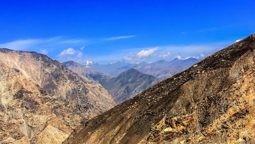 View of mountain range against blue sky