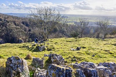 Scenic view of rocks on field against sky