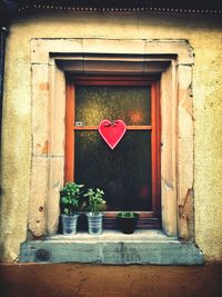 Heart shape on potted plant by door