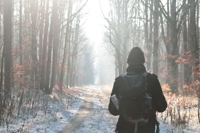 Rear view of man on snow covered land