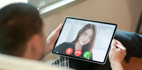 Rear view of woman using mobile phone