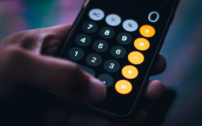 Close-up of person using calculator app on mobile phone