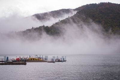 Panoramic view of people sailing in sea against sky