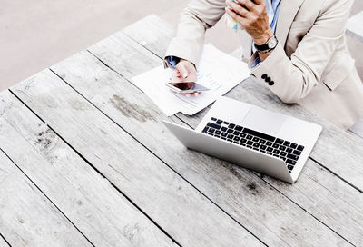 High angle view of man using laptop on table