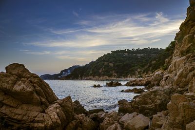 Scenic view of sea and mountains against sky