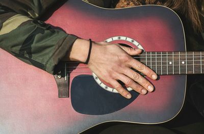 Close-up of man playing guitar