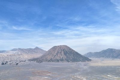 Scenic view of mountains against blue sky