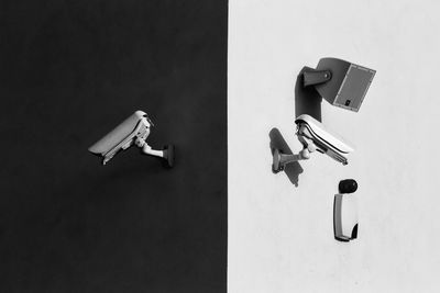 Low angle view of security cameras on wall