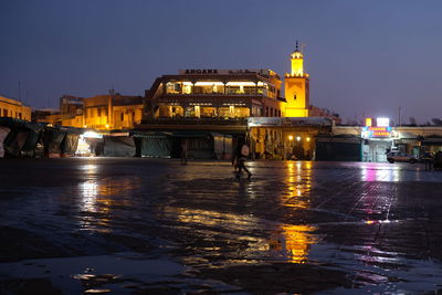 Reflection of illuminated buildings in water at night