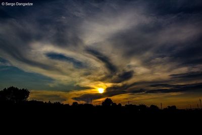 Scenic view of dramatic sky over silhouette landscape