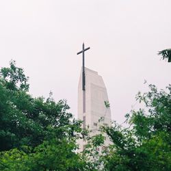 Low angle view of trees and buildings against sky