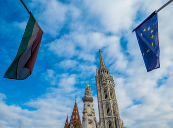 Low angle view of flag on building against sky