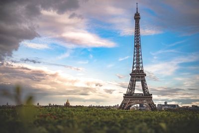 Tower on field against cloudy sky