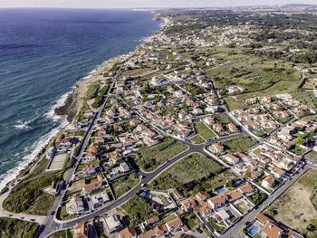 High angle view of townscape by sea