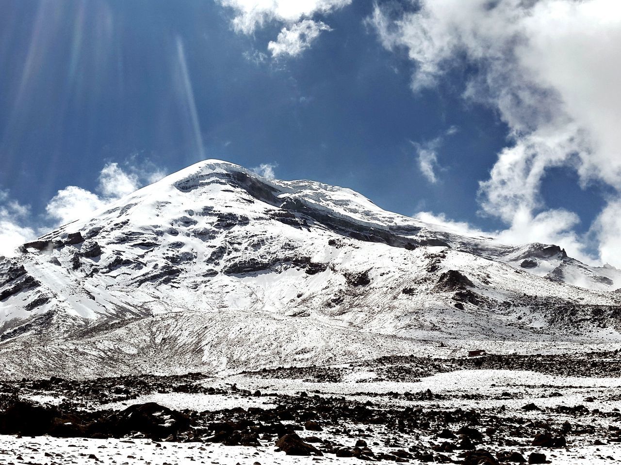 mountain, sky, low angle view, tranquility, tranquil scene, scenics, nature, beauty in nature, mountain range, landscape, non-urban scene, sunlight, snow, cloud - sky, cloud, day, rocky mountains, tree, remote, outdoors