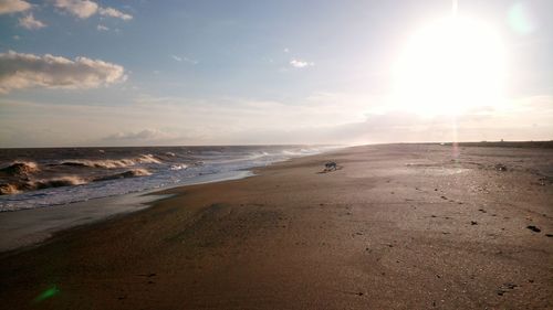 Scenic view of beach against sky during sunset