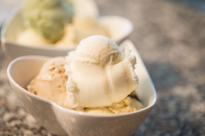 Close-up of vanilla ice cream in bowl on table