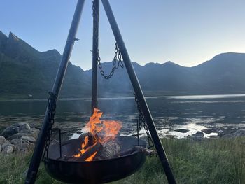 Scenic view of sea against sky with campfire