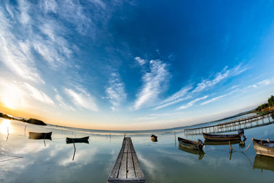 Scenic view of pier against sky at sunset