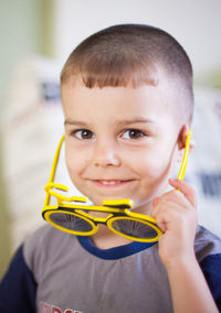 Portrait of cute boy wearing novelty glasses