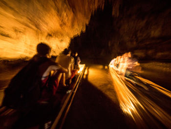 Blurred motion of people on road at night