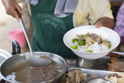 Midsection of man preparing food on table