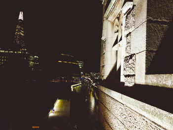 Street amidst buildings in city at night