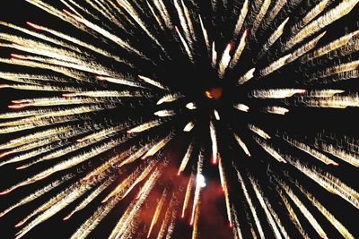 Low angle view of firework display at night