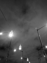 Low angle view of illuminated lights against sky at night