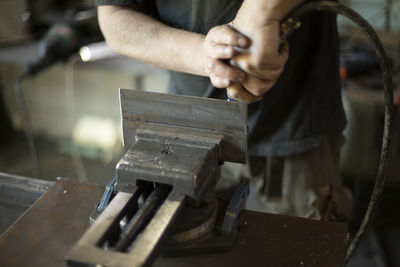 Cropped hand of man working at workshop