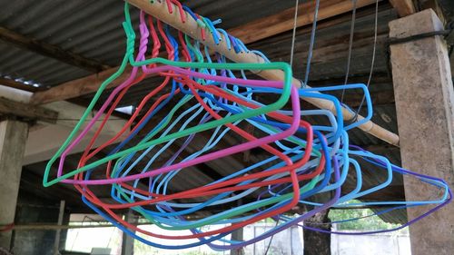 Close-up of multi colored umbrellas on cable