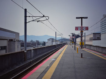 Railroad station platform against clear sky