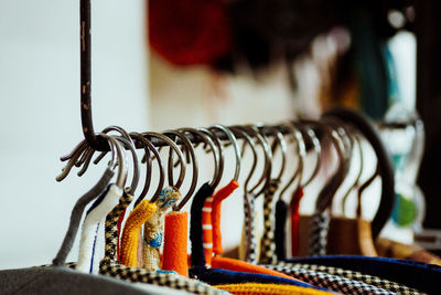 Close-up of coat hangers on rack