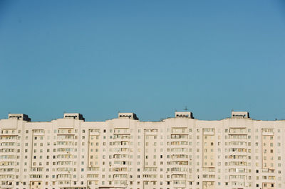 Low angle view of buildings against clear blue sky