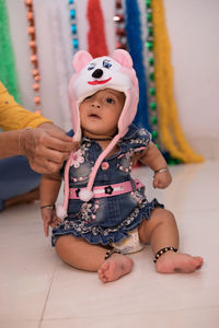 Portrait of cute baby girl at home