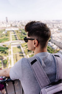 Rear view of young man looking at city