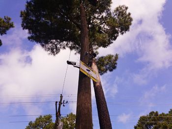 Low angle view of electricity pylon against sky