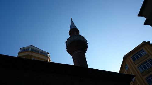 Low angle view of buildings against clear blue sky