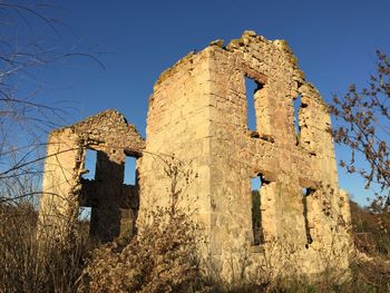 Low angle view of old building against clear sky