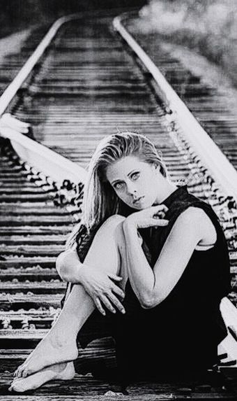 CLOSE-UP OF WOMAN STANDING ON WALL