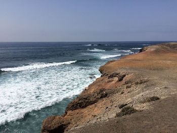 Scenic view of beach against clear sky