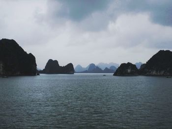 Scenic view of sea and mountains against sky