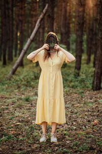 Woman with mirror instead of face on the forest background. mindfulness, mind and soul, mental