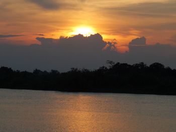 Scenic view of silhouette trees against romantic sky at sunset