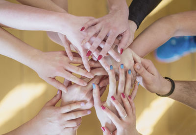 High angle view of stacked hands