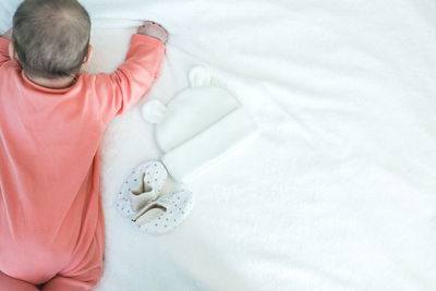 High angle view of woman resting on bed