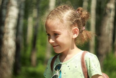 Portrait of cute girl lying on land