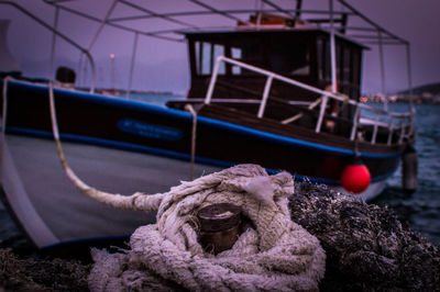 Close-up of toy boat moored at shore