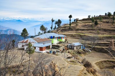 Houses by mountains against sky